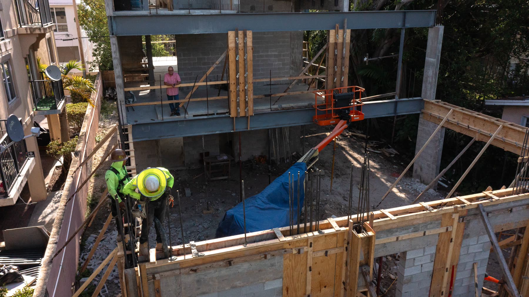 Structural steel landing on the concrete and block frame during construction at Leslie House.