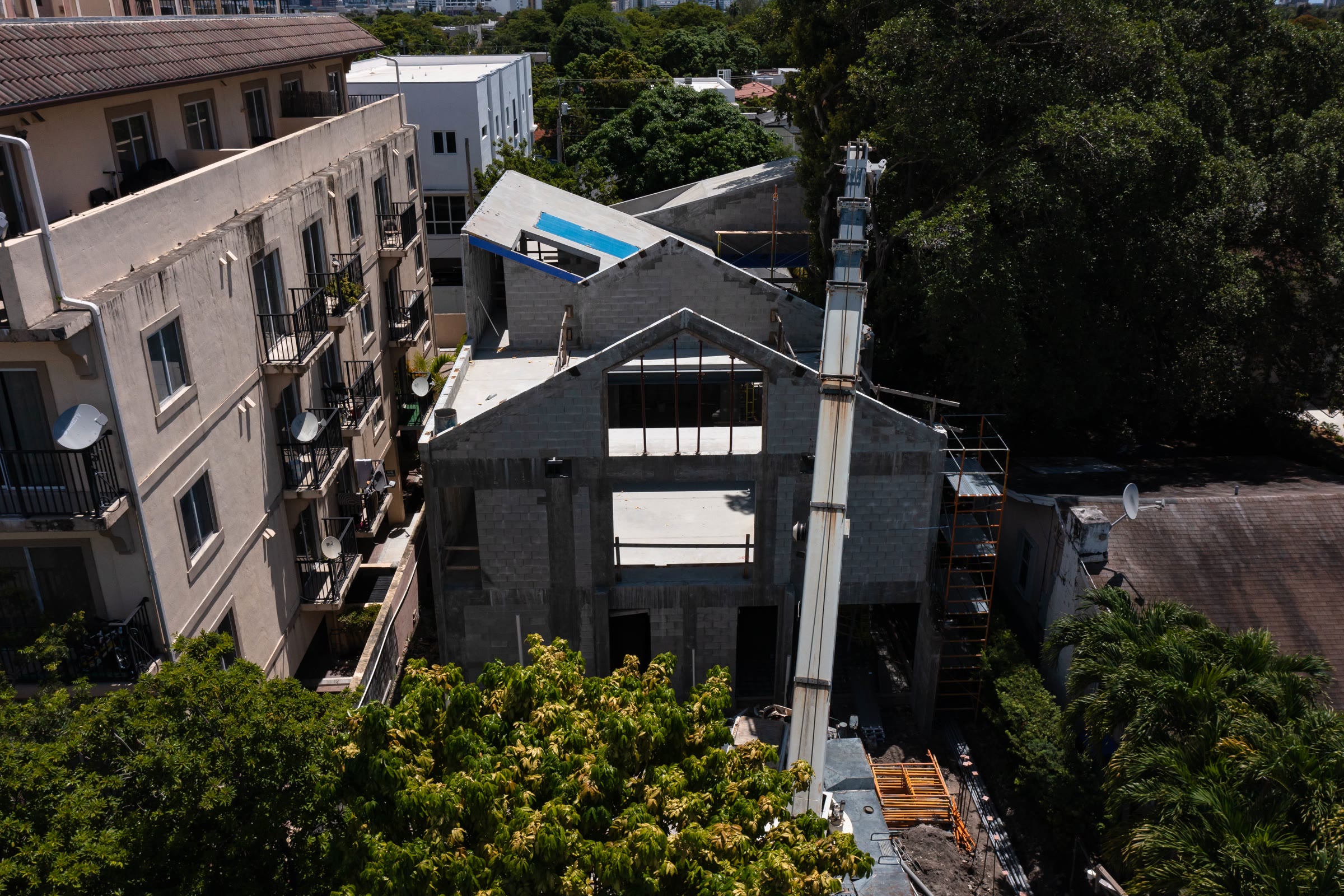 The structure itself, before any of it was covered. Block and concrete walls, the folded roof planes taking shape, the…