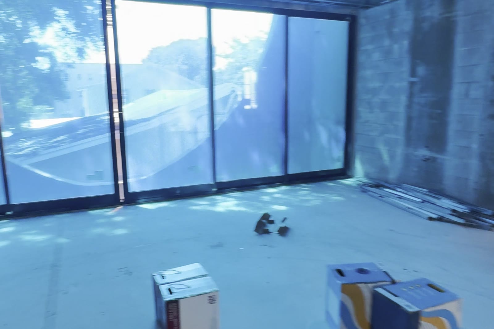 A room delivered as glass on three sides, before a single finish went in.