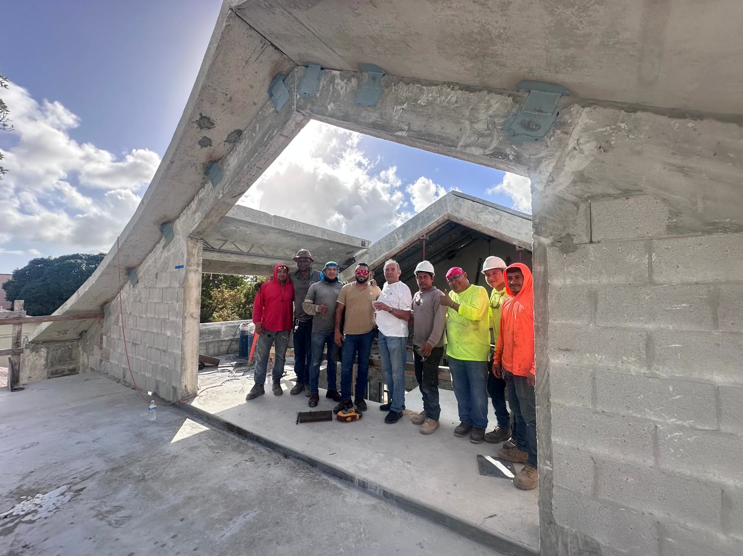 The shell crew in the opening they had just built. Leslie among them — the people who actually stood the building up.