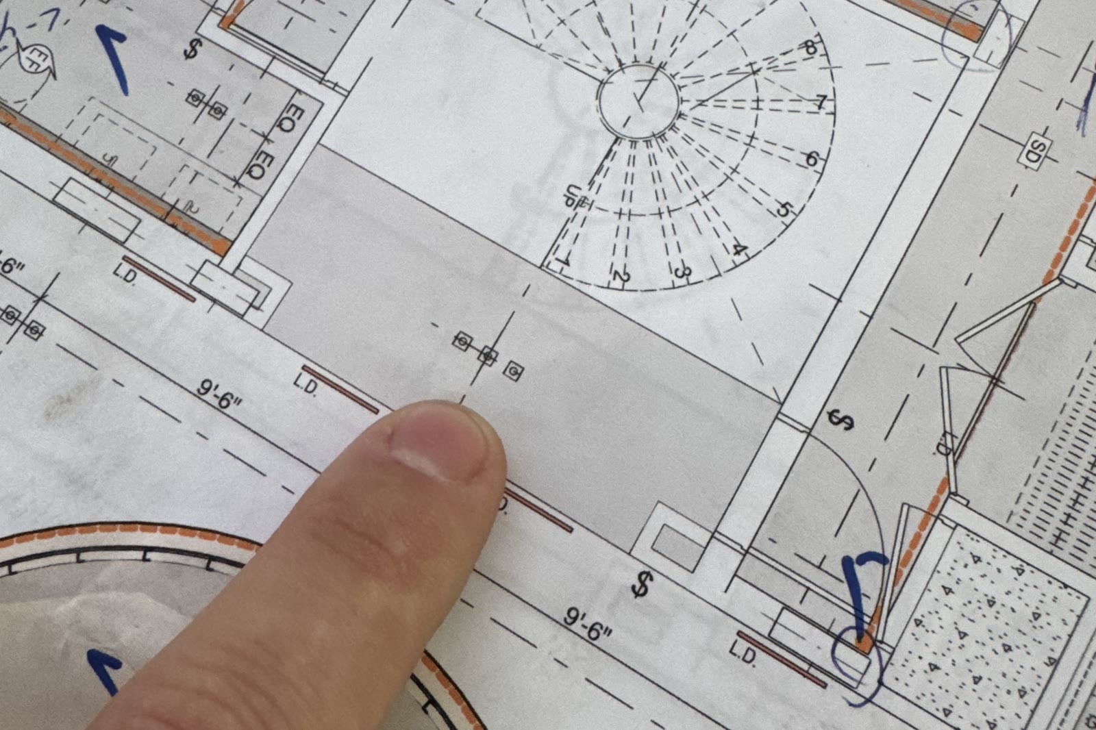 Closer: a finger at the spiral stair's plan geometry, dimension callouts around the perimeter. This is the problem the…