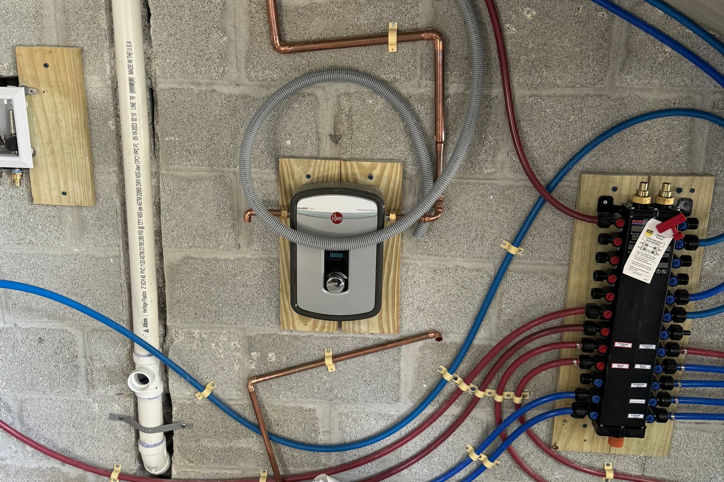Plumbing, self-performed. The manifold is Academia's own license of record too — every fixture on its own run…